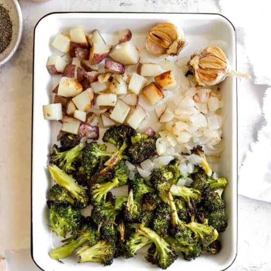 A cheesy baking dish with broccoli and potatoes, flavored with garlic.