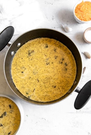 a pan with a bowl of broccoli cheese soup.