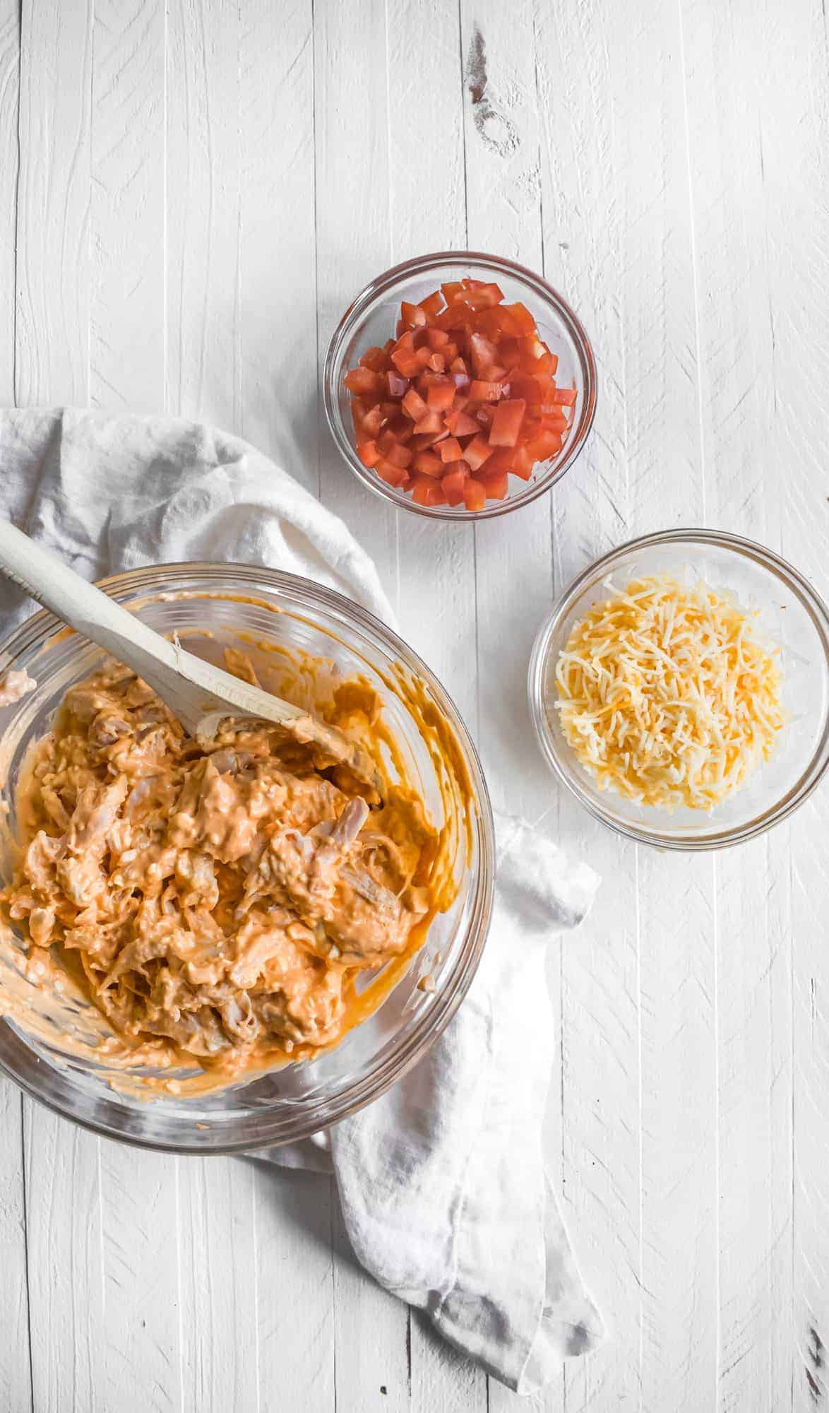 Buffalo chicken nacho ingredients in bowls. 