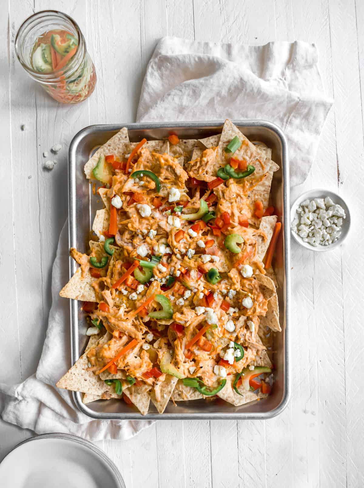 Buffalo chicken nachos on a pan. 