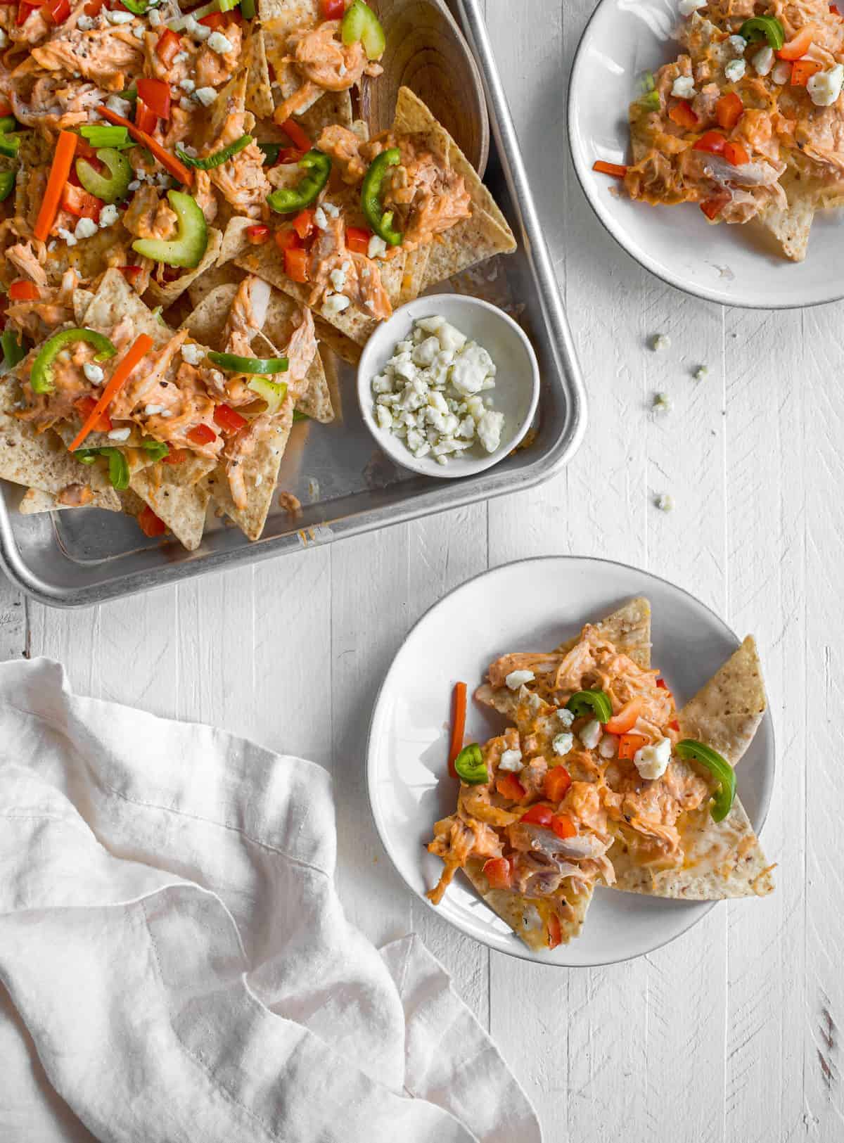 Buffalo chicken nachos on a pan and on two plates! 