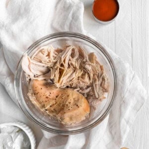 Buffalo shredded chicken on a white table.