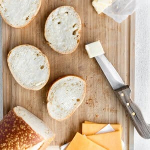 Classic grilled cheese sandwich on a cutting board.