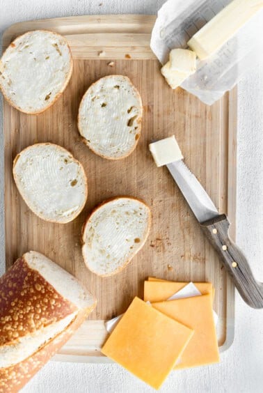 Classic grilled cheese sandwich on a cutting board.