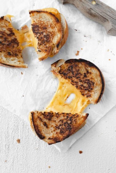 Two slices of grilled cheese on a piece of paper.