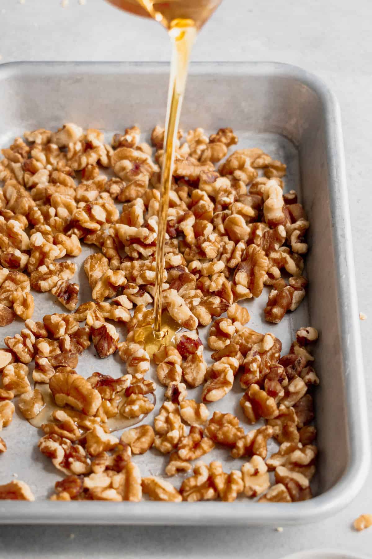 Pouring honey over walnuts