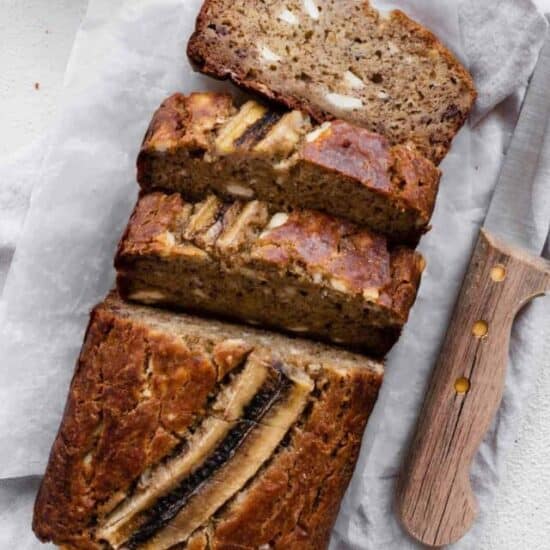 a close up image of cream cheese banana bread cut into slices