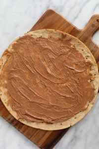 a fruit pizza with peanut butter on top.