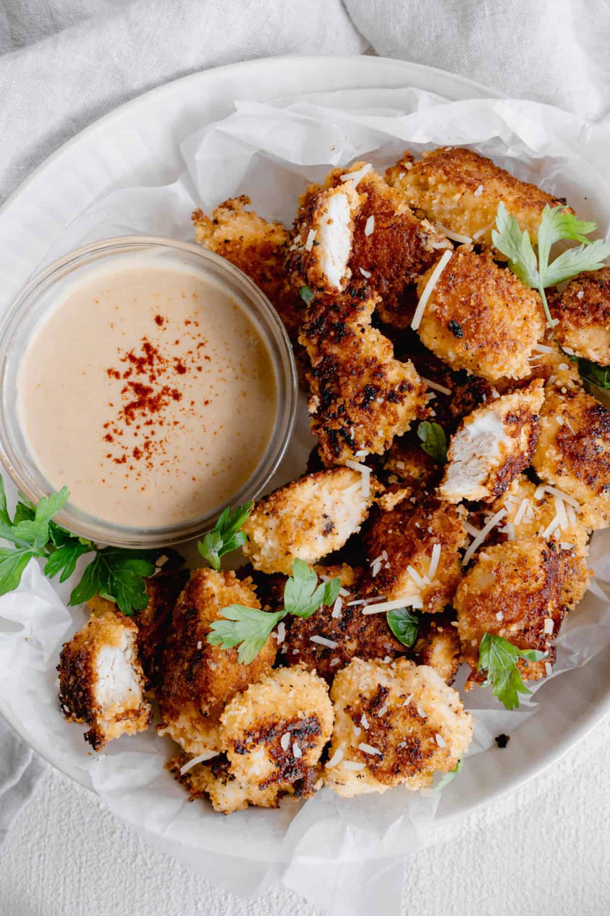 chicken nuggets on plate with dipping sauce.