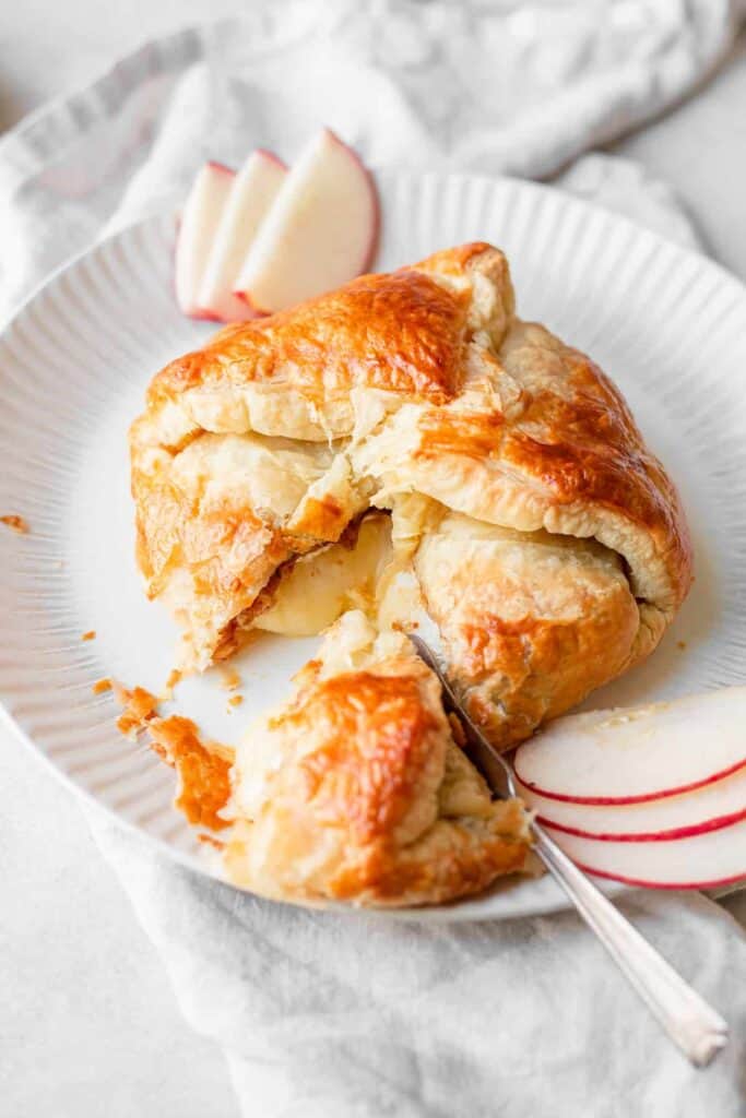 baked brie with fig jam on plate.