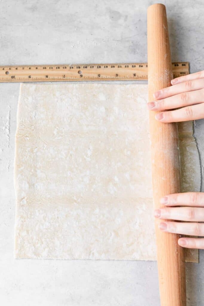 rolling out puff pastry.