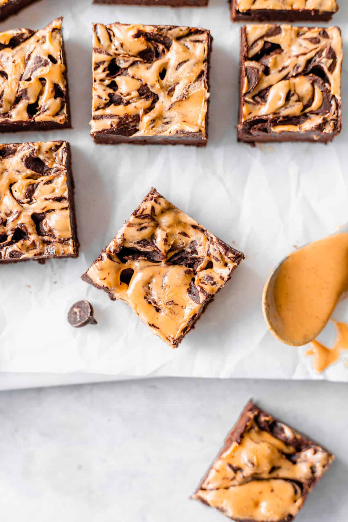 Peanut butter swirl cream cheese fudge on wax paper.