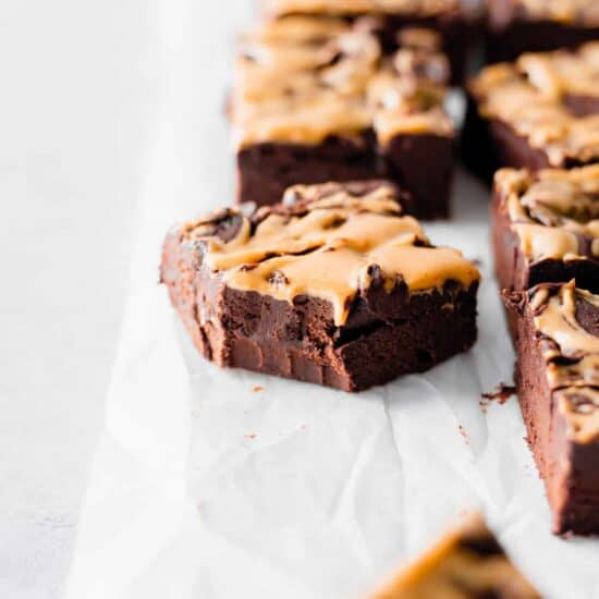 a plate of chocolate brownies with peanut butter icing.
