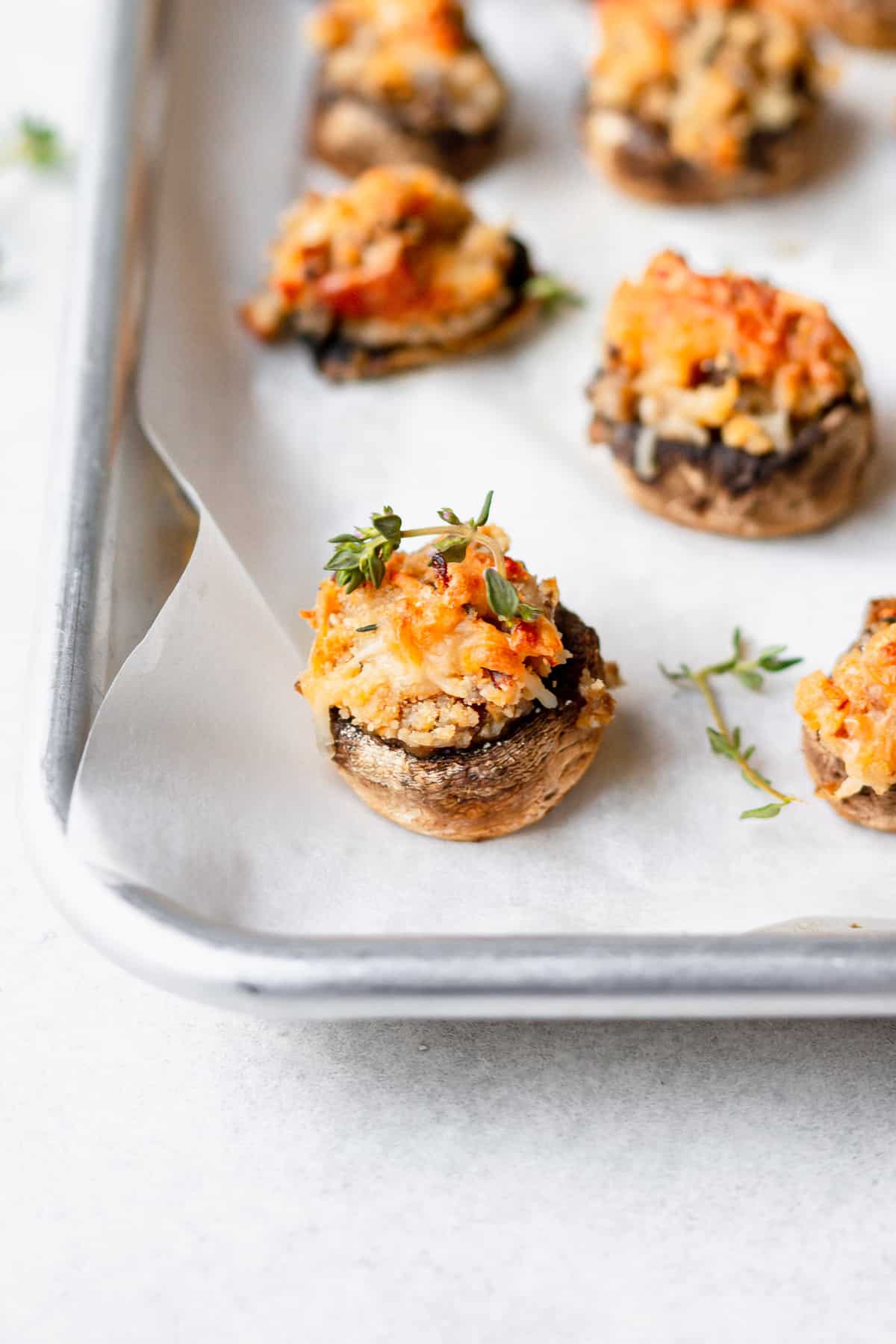 cream cheese stuffed mushrooms on a baking tray