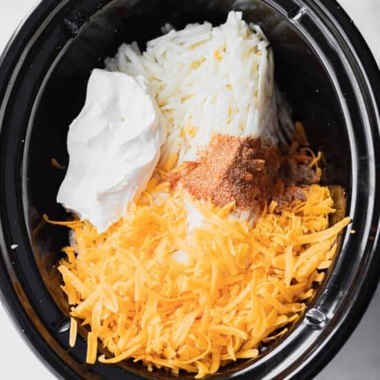 a cheesy crock pot filled with potatoes.