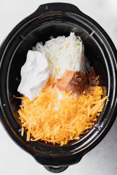 a cheesy crock pot filled with potatoes.