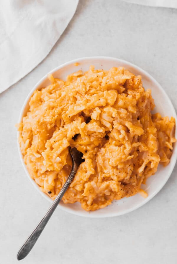 cheesy potatoes on plate with fork