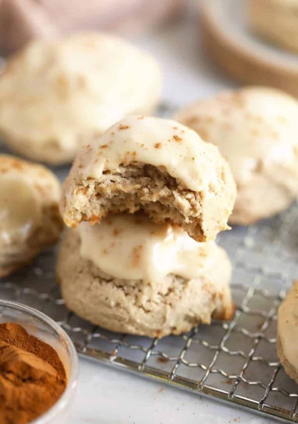 2 pumpkin spice cream cheese cookies stacked on a cooling rack