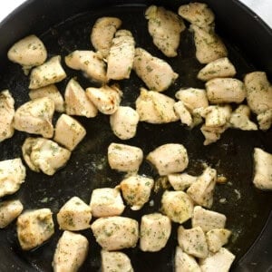 Chicken breasts cooked in a cast iron skillet, transformed into a flavorful chicken bacon ranch casserole.