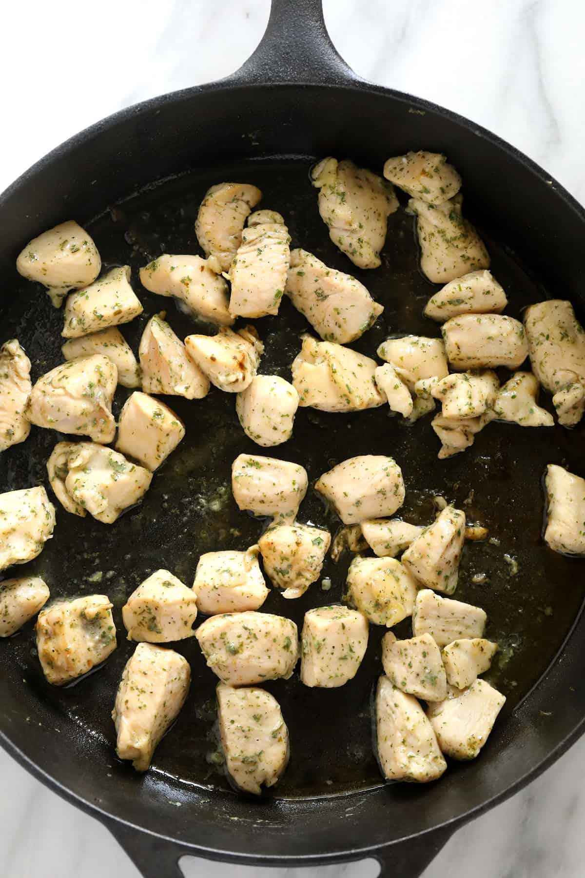 chunks of chicken being sauteed for chicken bacon ranch casserole