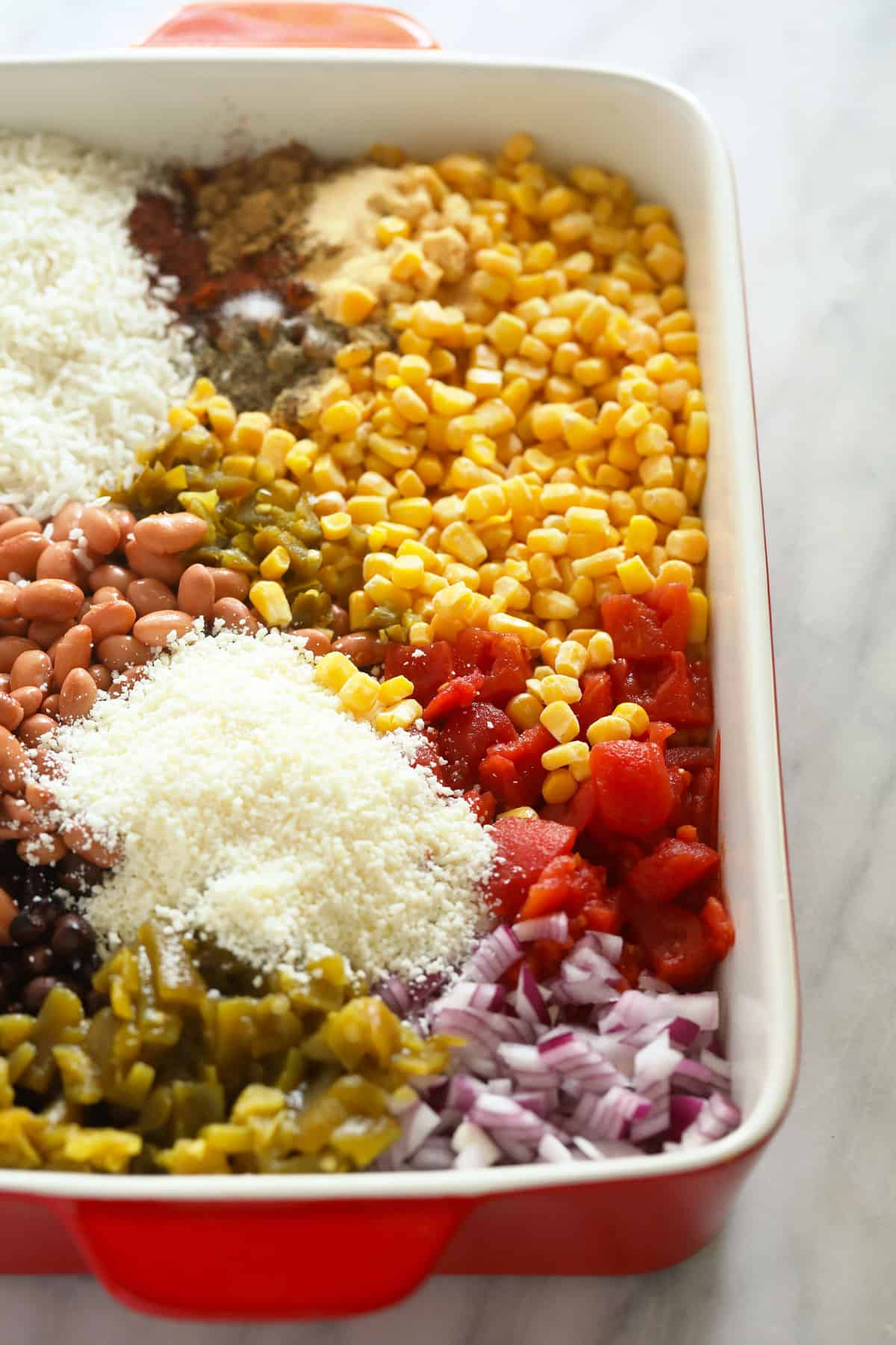 mexican street corn casserole ingredients in a casserole dish.