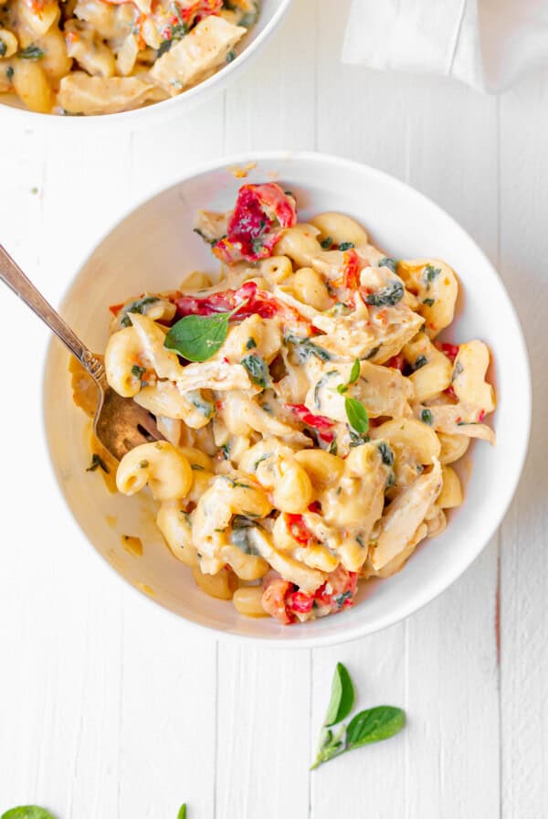 tuscan chicken mac and cheese in a bowl.