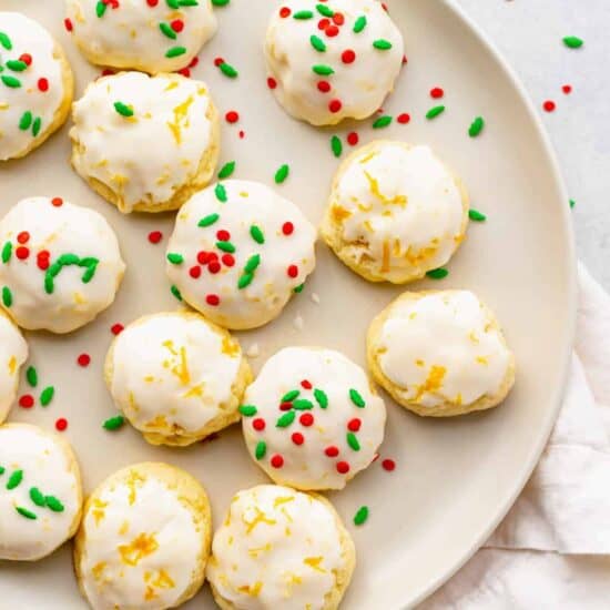 lemon sugar cookies on a plate with sprinkles.