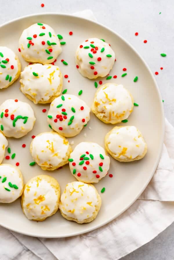 lemon sugar cookies on a plate with sprinkles.
