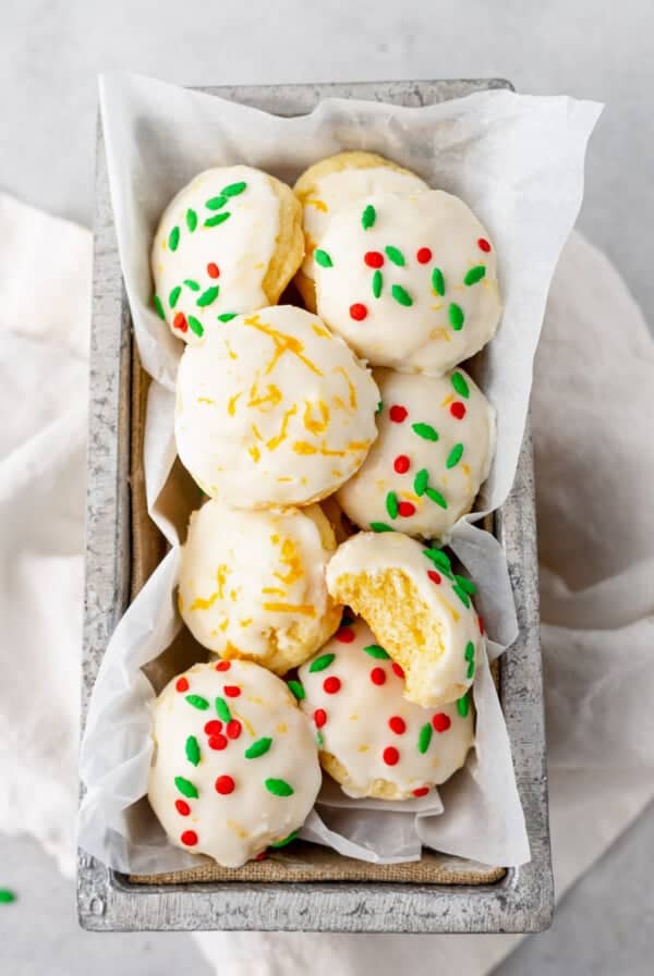 cookies in a box with sprinkles and icing.