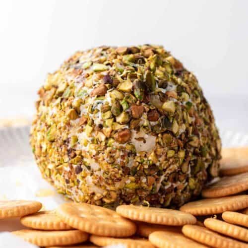 cheese ball on a plate with crackers around it