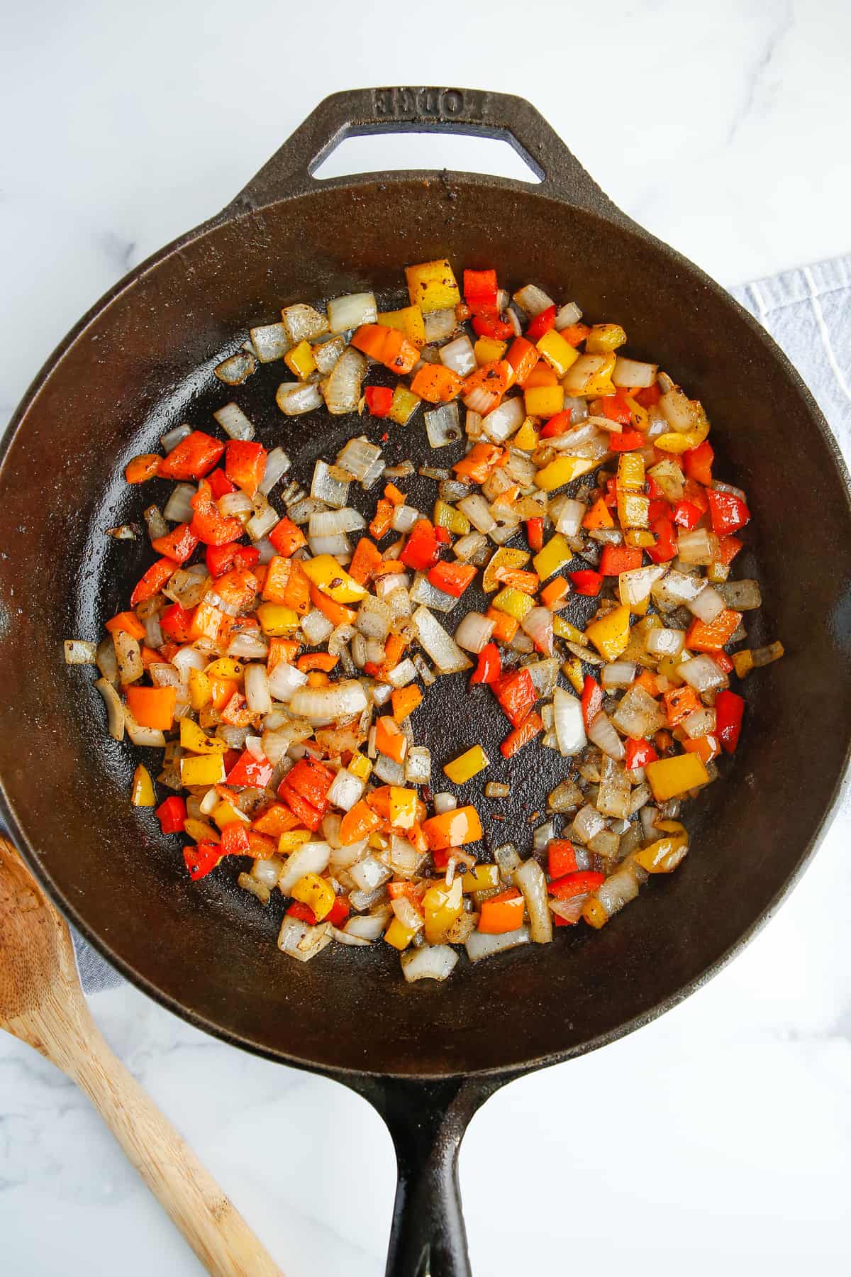 Peppers and onions in a cast iron pan. 