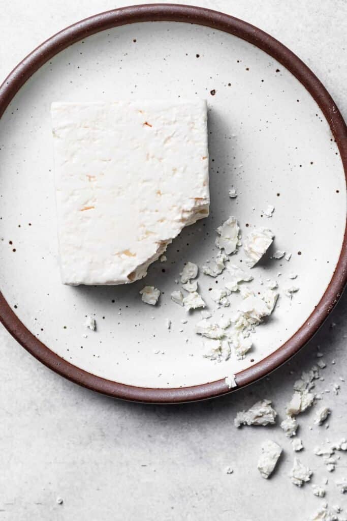 block of feta cheese on plate.