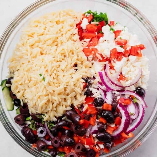 greek rice salad in a glass bowl.