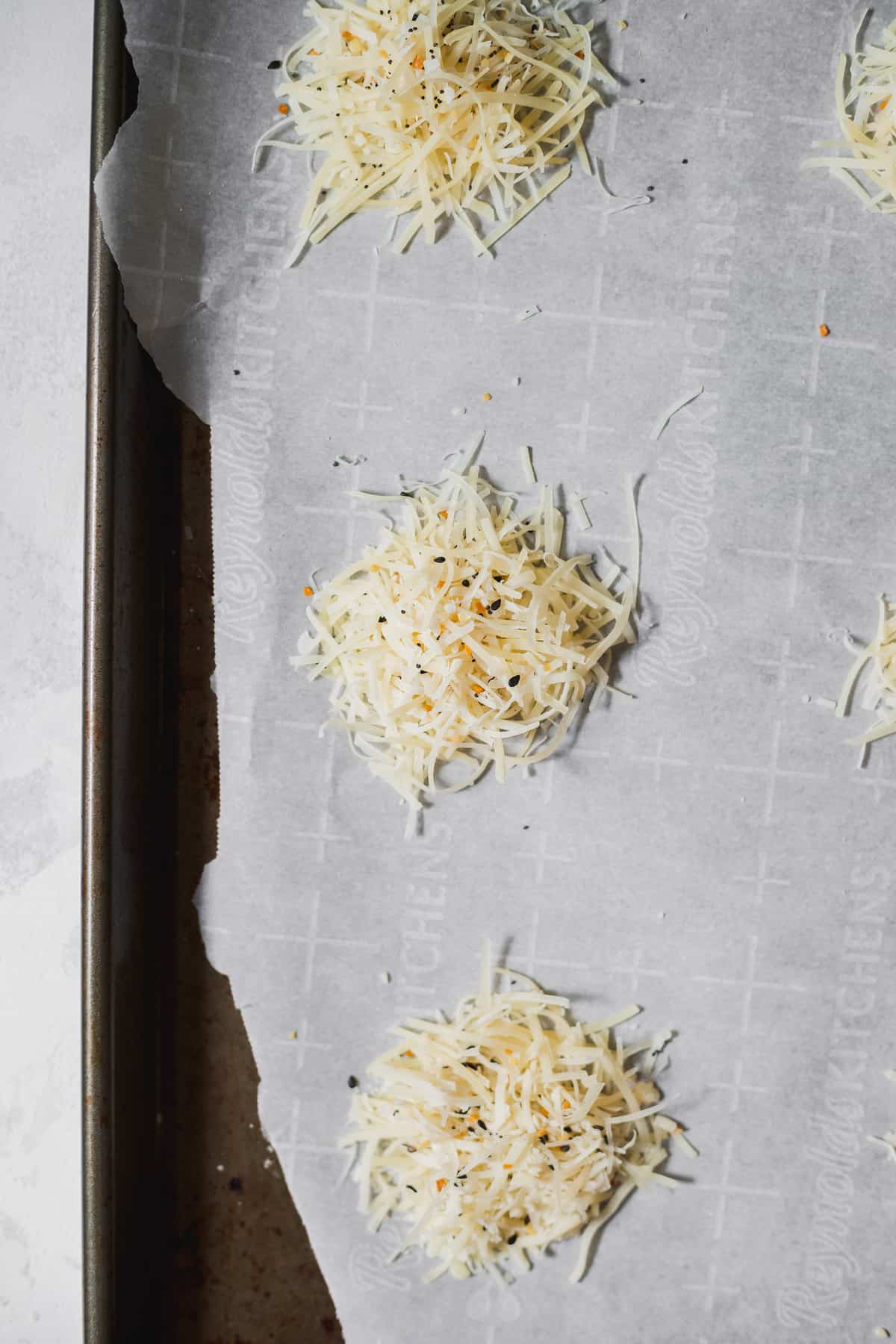 This parmesan crisps recipe is a fantastic 100 calorie snack that you can munch on all day long. Enjoy! parmesan cheese on baking sheet