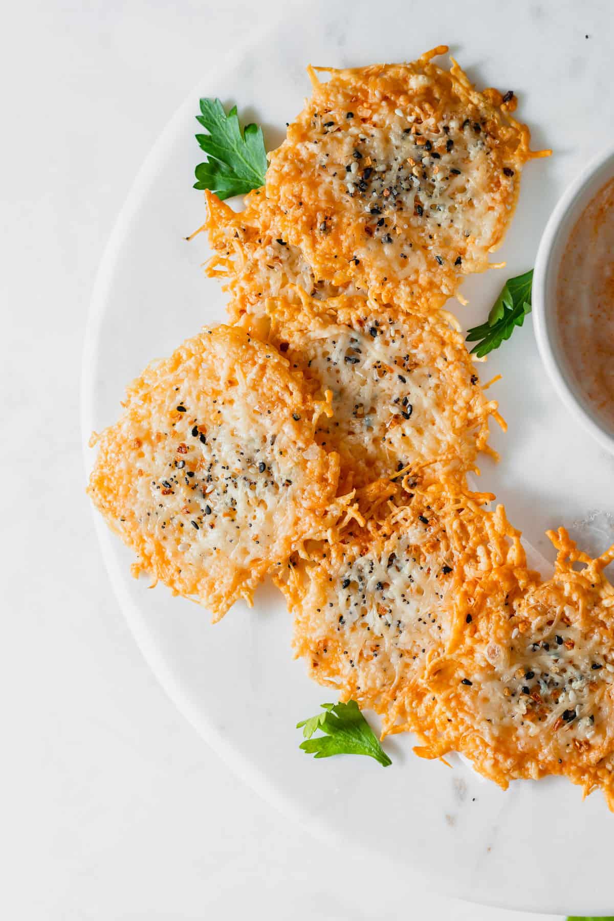 Enjoy these parmesan chips as a low-carb snack or salad/soup topper for some extra crunch. parmesan crisps on plate
