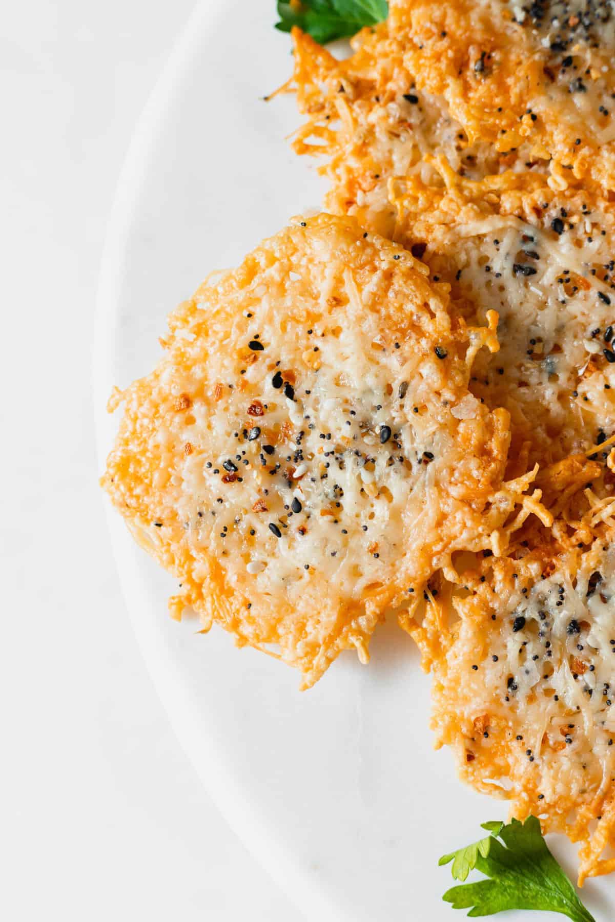 The easiest parmesan cheese crisps you'll ever make. These parmesan crisps are made with 1 main ingredient and are the best low-carb snack ever! parmesan crisps recipe on plate