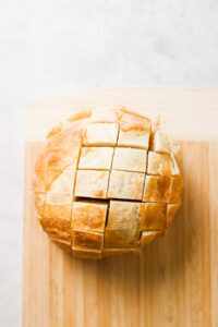 a loaf of bread on a cutting board.
