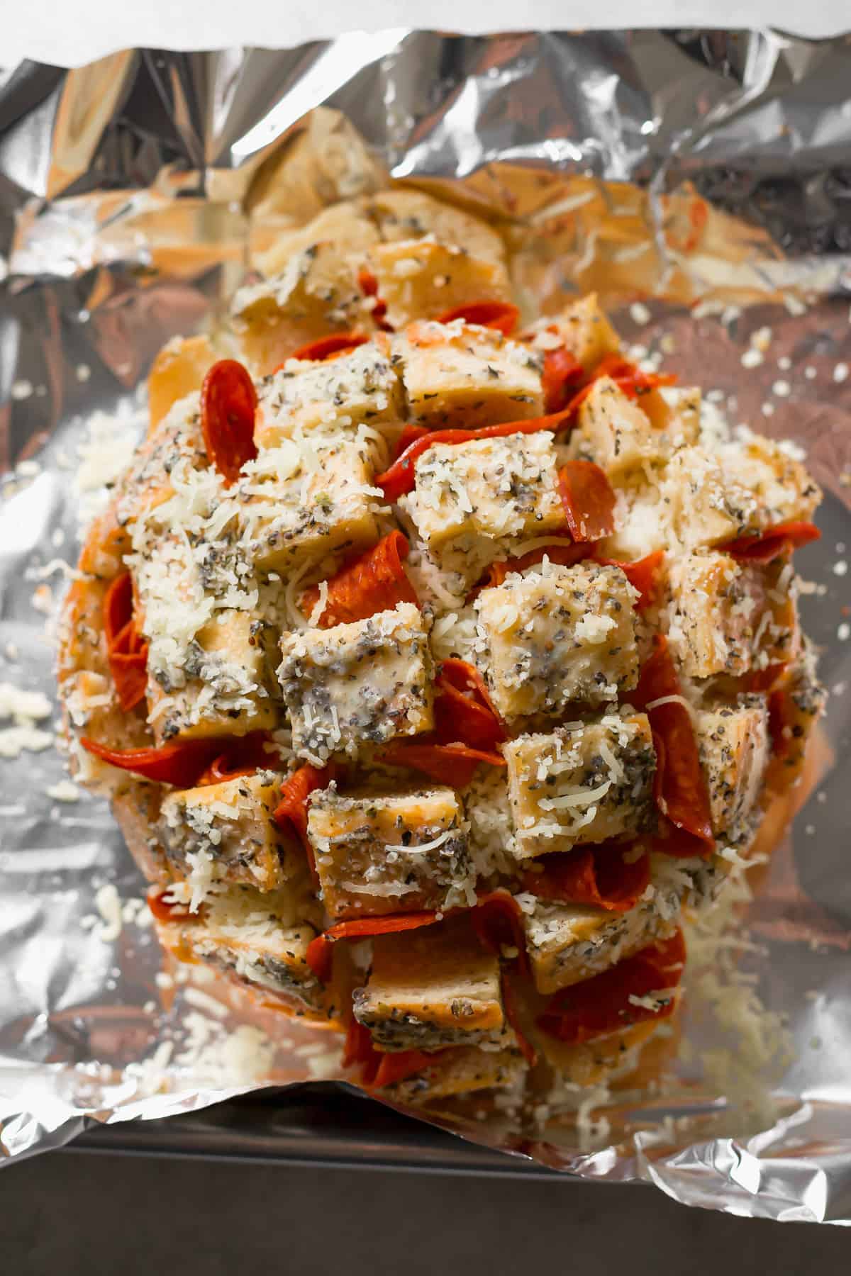 stuffing bread with pepperoni and shredded cheese