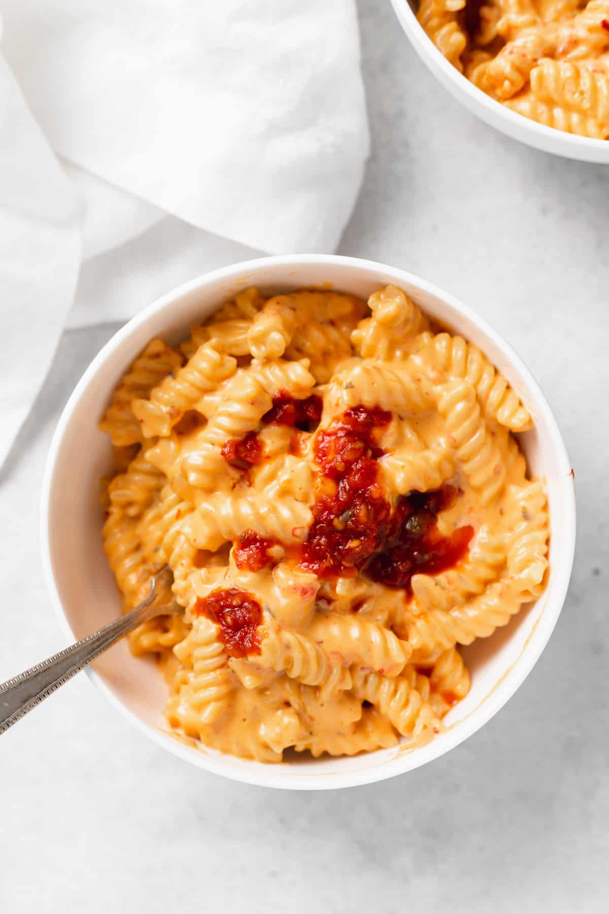 A bowl of queso dip mac and cheese 