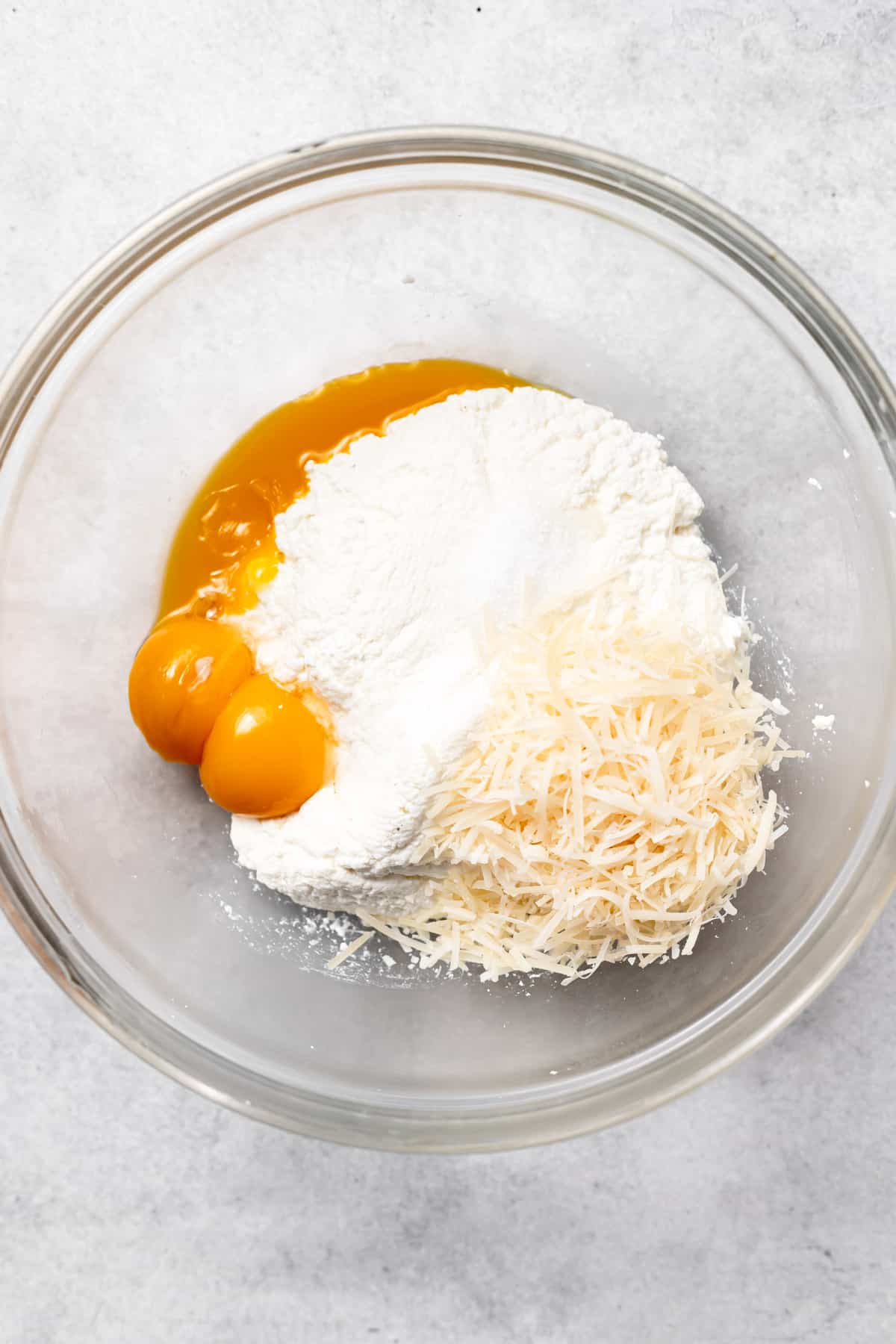 ricotta gnocchi ingredients in a bowl ready to be mixed together.