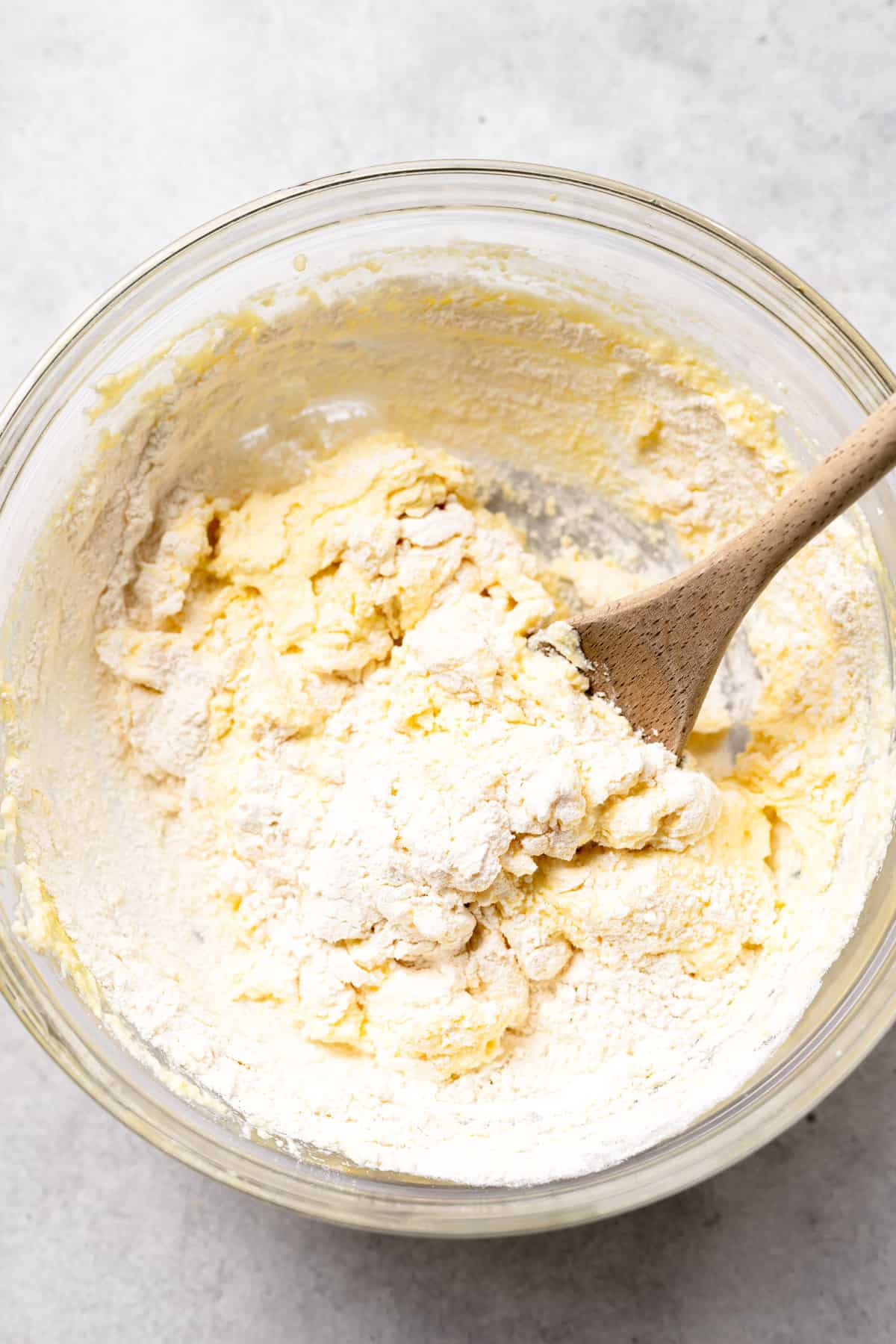 ricotta gnocchi dough being mixed together in a bowl.