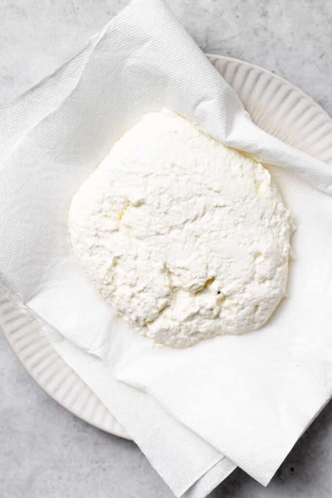 removing the moisture from ricotta cheese to be used in ricotta gnocchi.