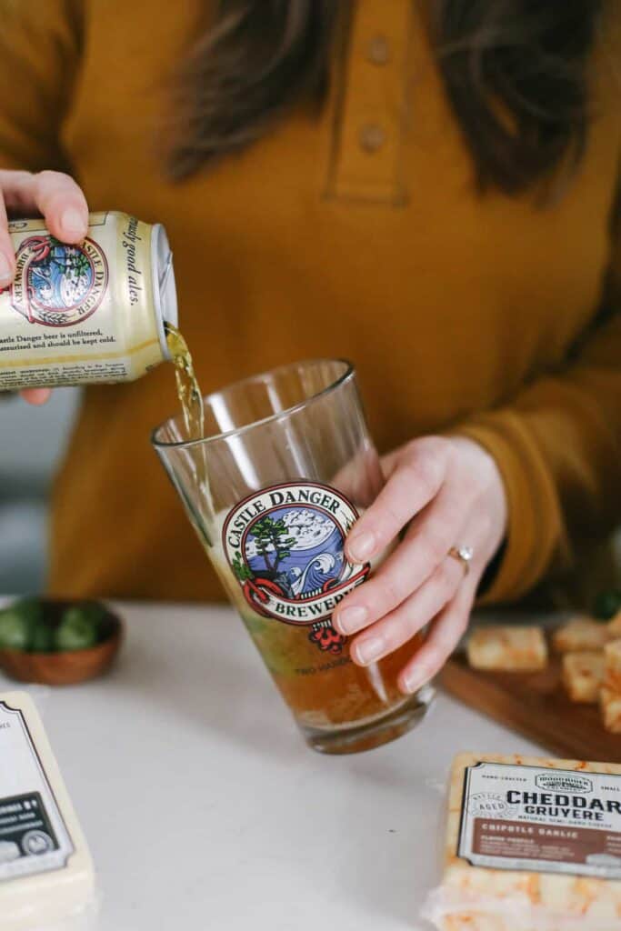 Castle Danger beer being poured into a glass with green olives