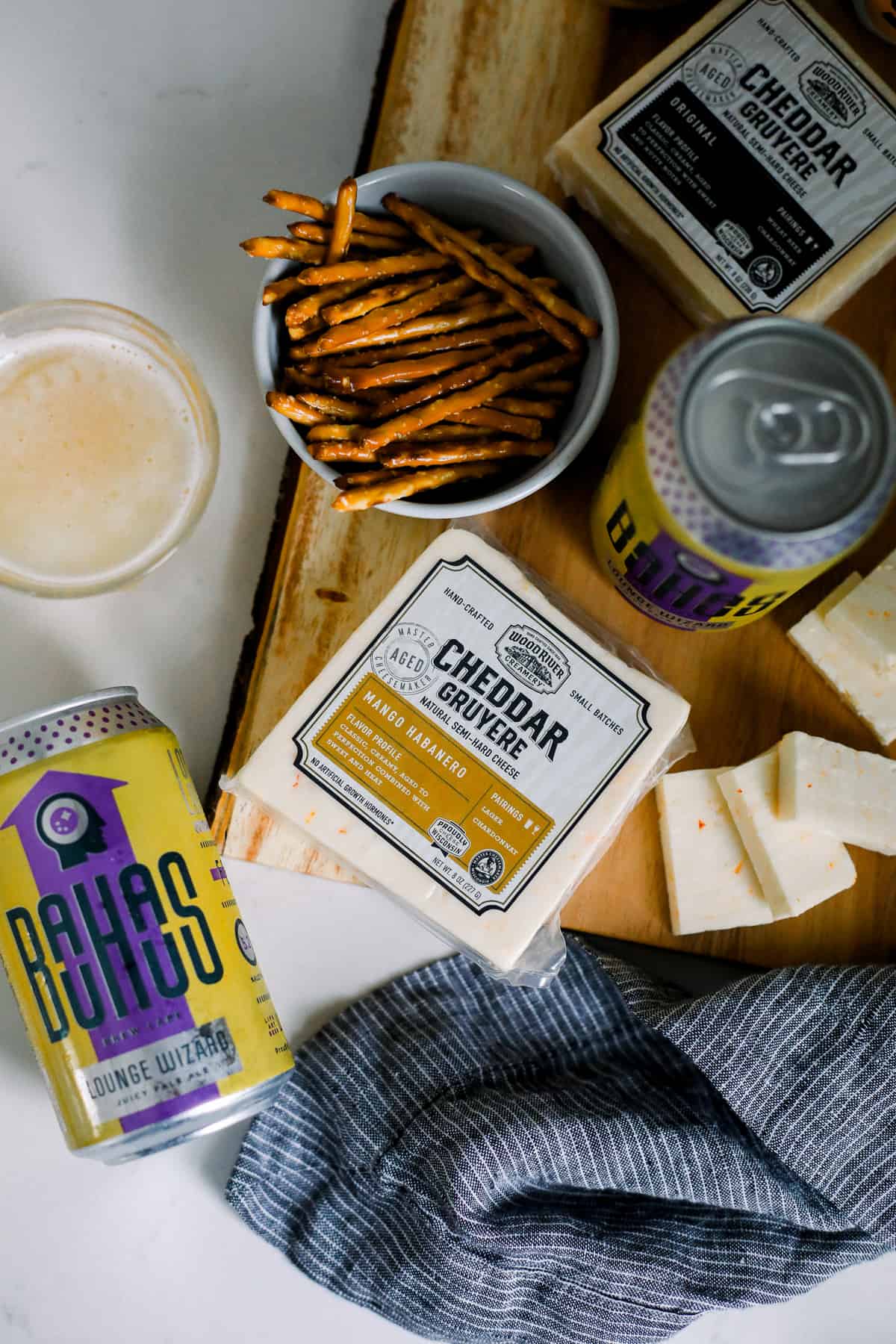 beer and cheese and pretzel pairings on a cutting board