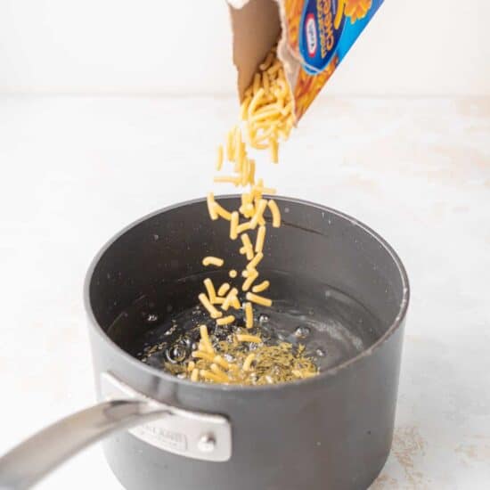 adding noodles to water.