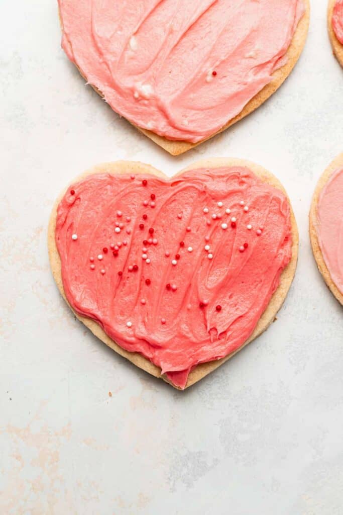 cream cheese heart cookies with pink frosting and sprinkles