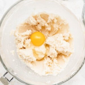 a heart-shaped cookie cutter placed on dough.