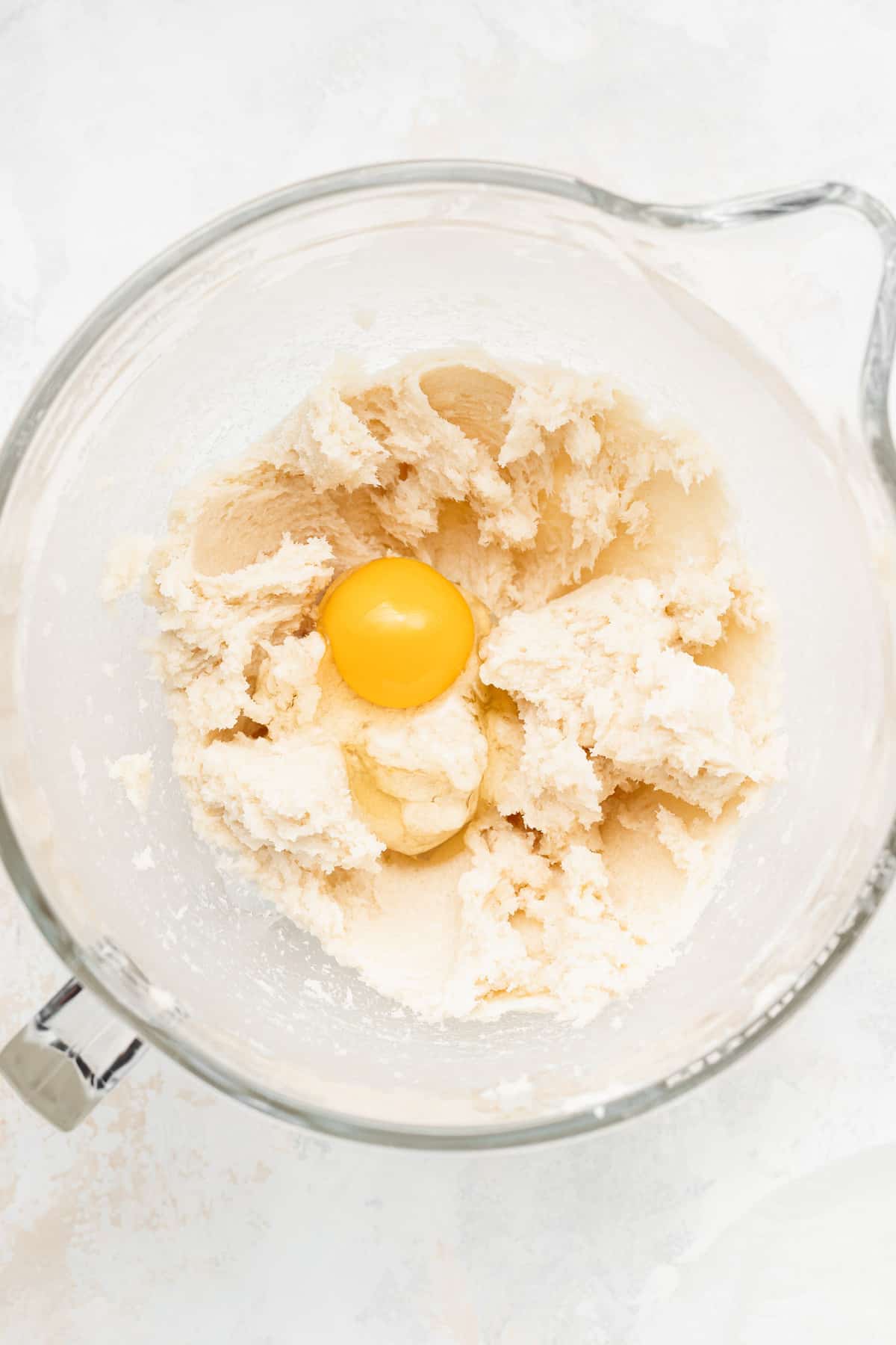 cream cheese sugar cookie ingredients in a bowl, ready to be mixed into a dough