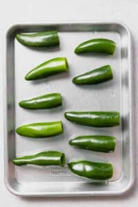 green jalapeno peppers on a baking sheet.