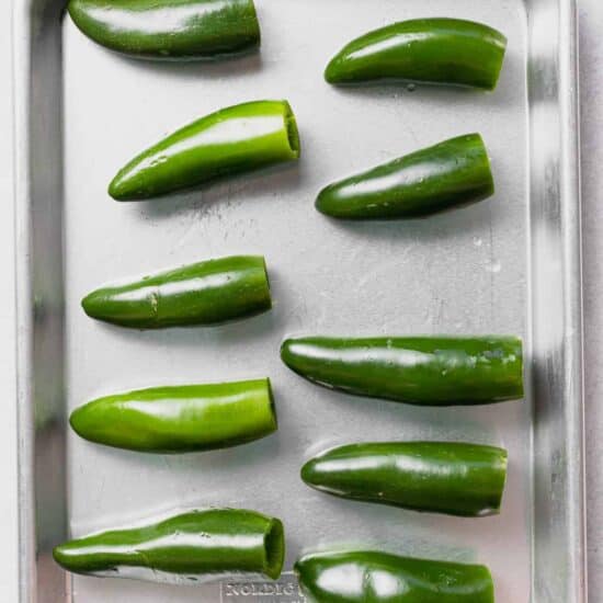 green jalapeno peppers on a baking sheet.